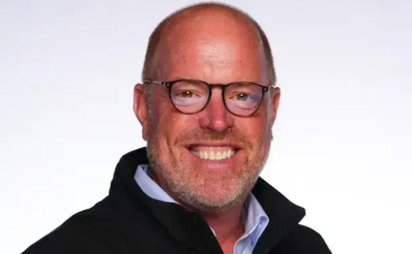 A person wearing glasses and a black jacket AI-generated content may be incorrect.