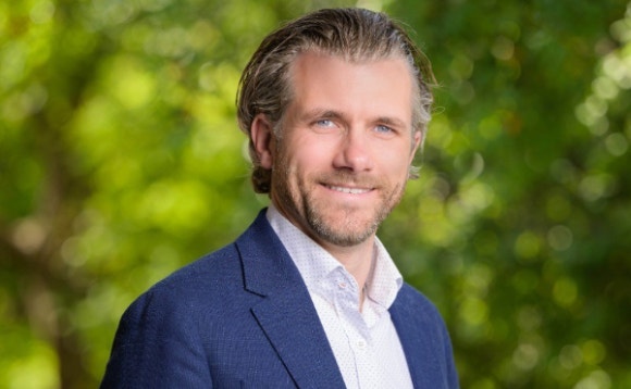 A person in a blue suit AI-generated content may be incorrect.
