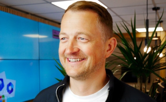 A person smiling for the camera AI-generated content may be incorrect.