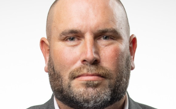 A person with a beard AI-generated content may be incorrect.