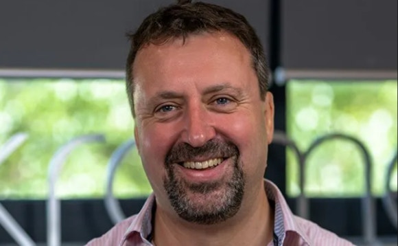 A person with a beard smiling AI-generated content may be incorrect.