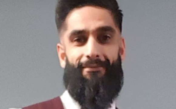 A person with a beard AI-generated content may be incorrect.